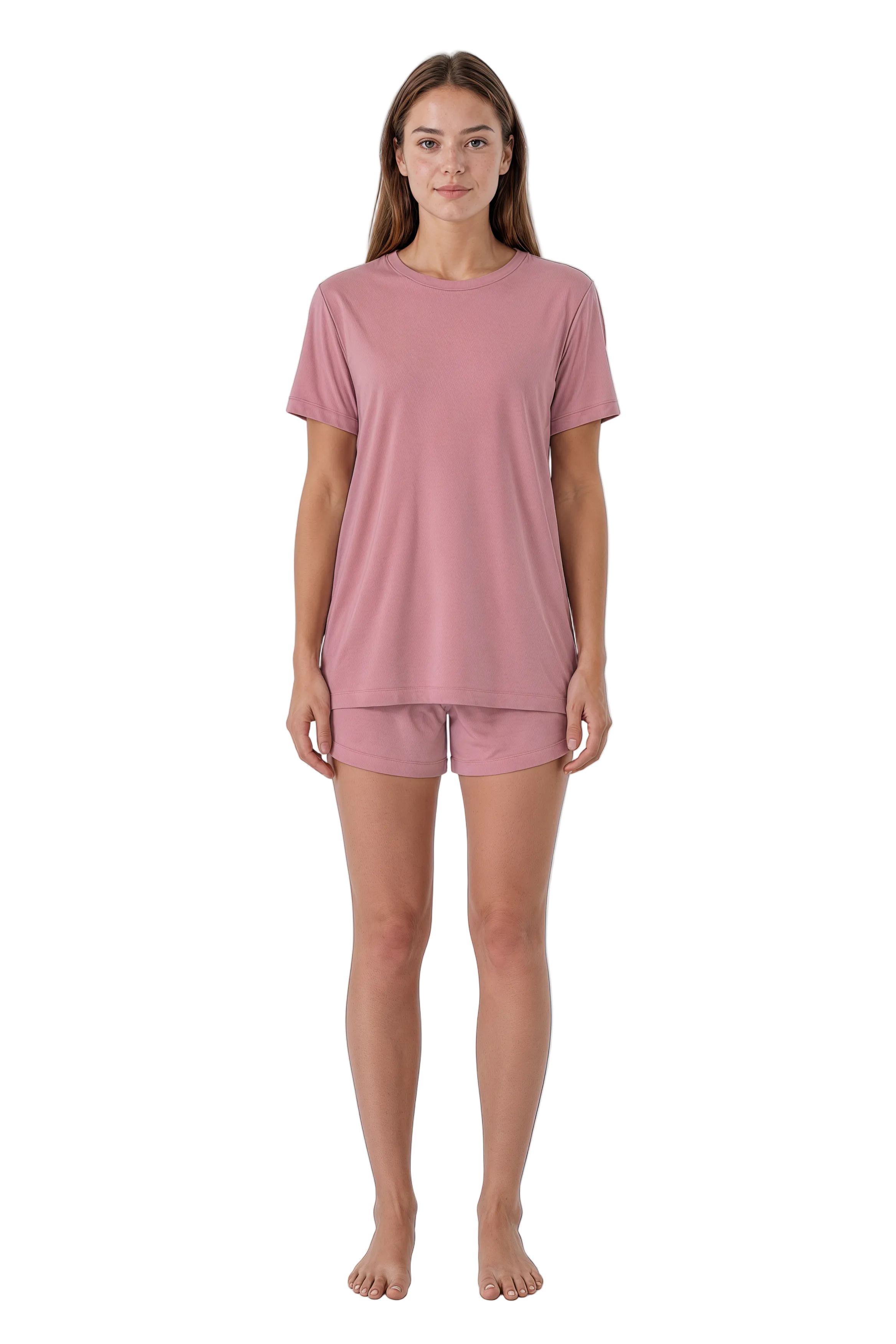 A woman modeling a dusty pink short-sleeve t-shirt and matching shorts pajama set against a plain white background.