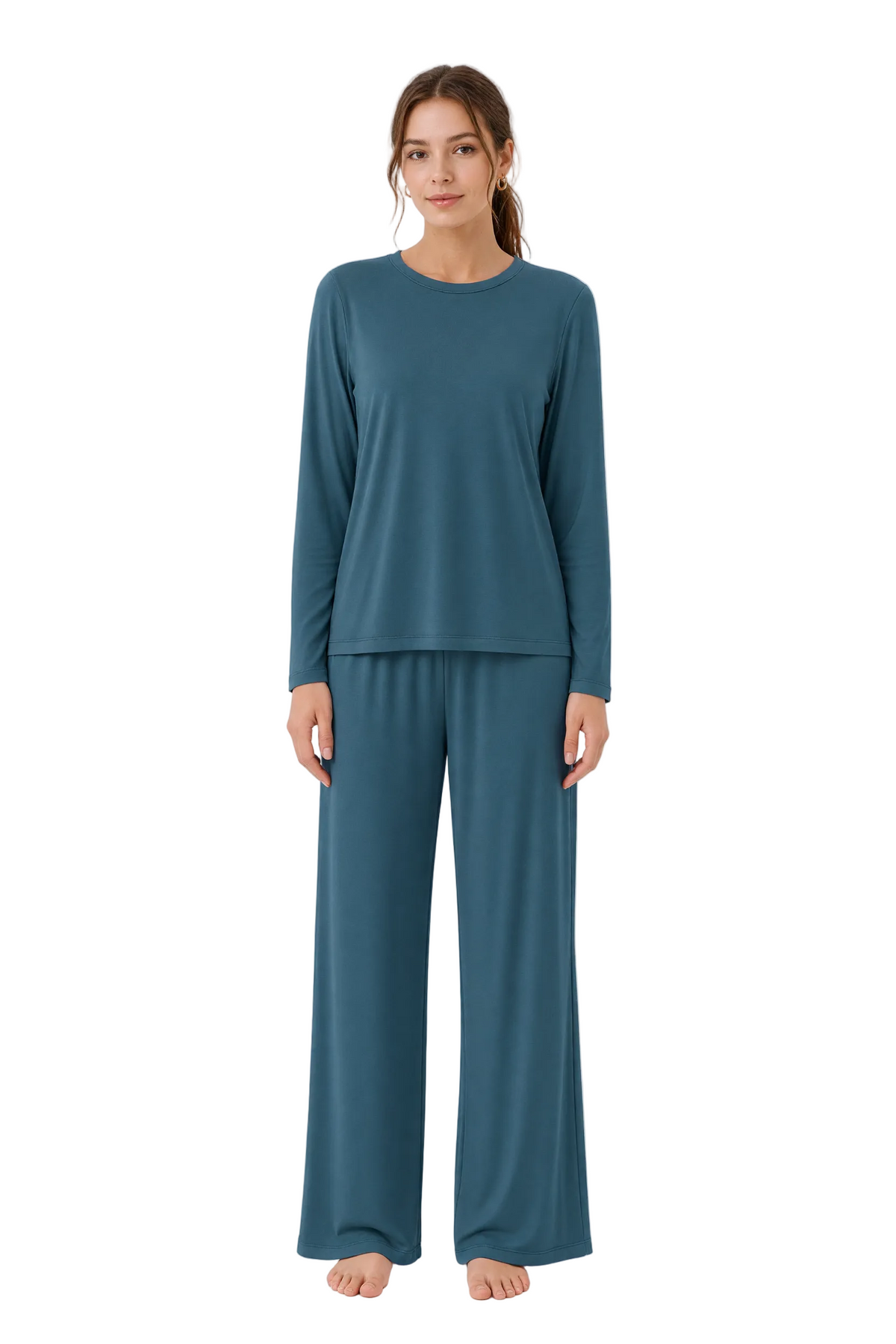 A woman modeling a two-piece long-sleeve pajama set in a muted teal blue color, consisting of a crewneck top and matching wide-leg pants, against a plain white studio background.