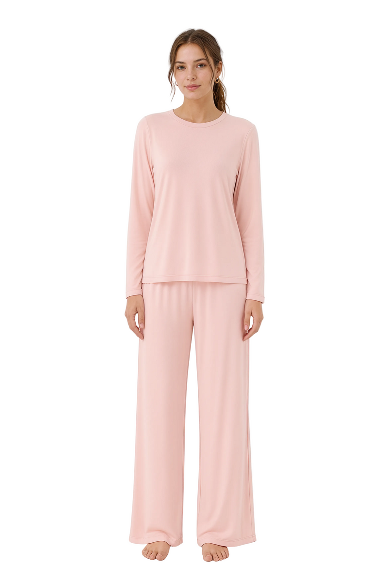 Woman wearing a pink pajama set on a white background
