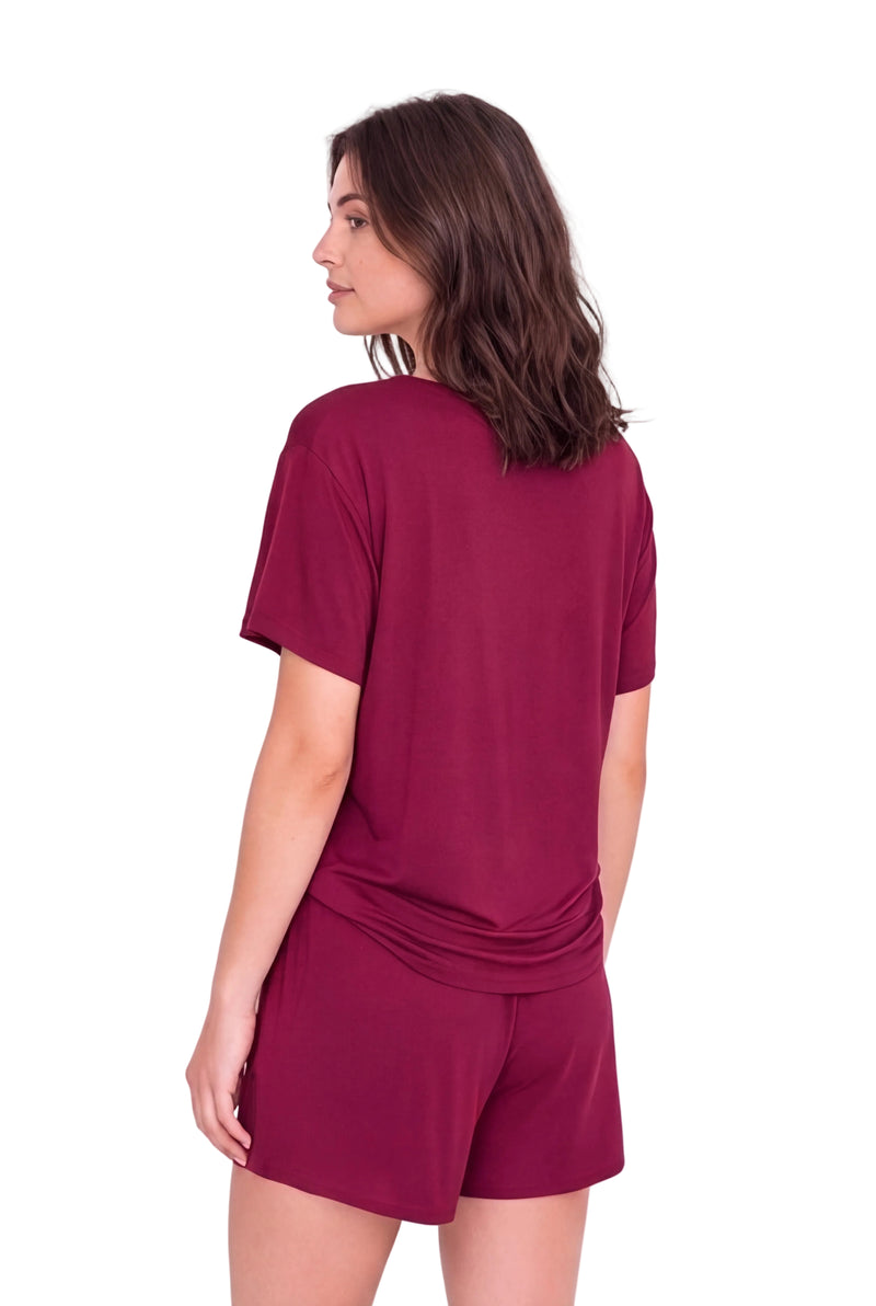 A woman shown from the back wearing a matching short-sleeve top and shorts set in a deep wine or burgundy color, against a plain light background.